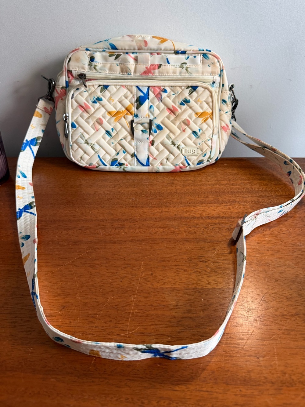 Lug crossbody bag firefly pattern on cream background